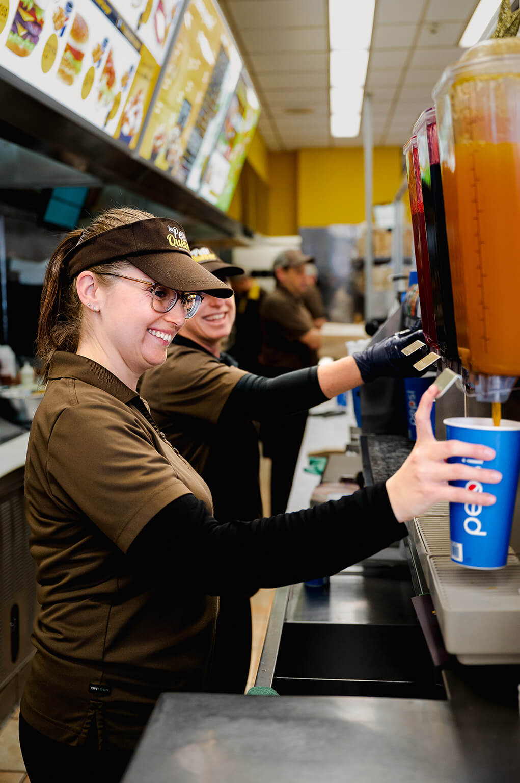 Woman serving drinks in a fast-food restaurant