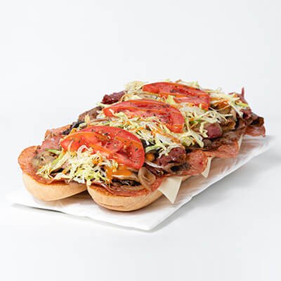 Submarine sandwich with cheese, smoked meat, pepperoni, steak, lettuce, tomatoes, mushrooms and onions, on a white background