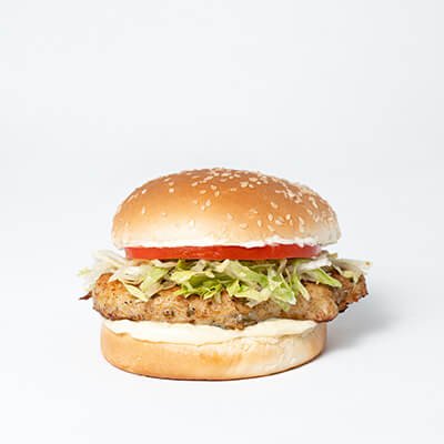 Hamburger in a white bun with grilled chicken, lettuce, tomato, mayonnaise, on a white background