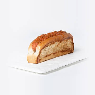 Hot dog in a toasted white bun with sausage, and michigan or italian sauce, on a white background