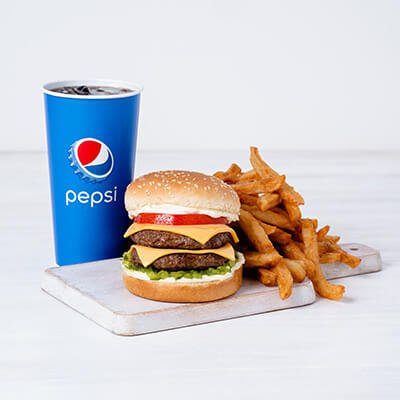 Trio double cheeseburger, fries and pepsi drink on white background