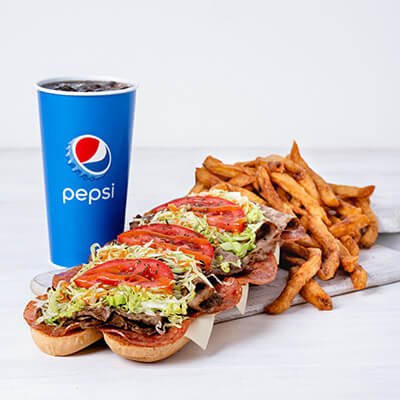 Submarine trio with minced steak, lettuce, tomatoes on a toasted bread and fries and Pepsi drink on a white background